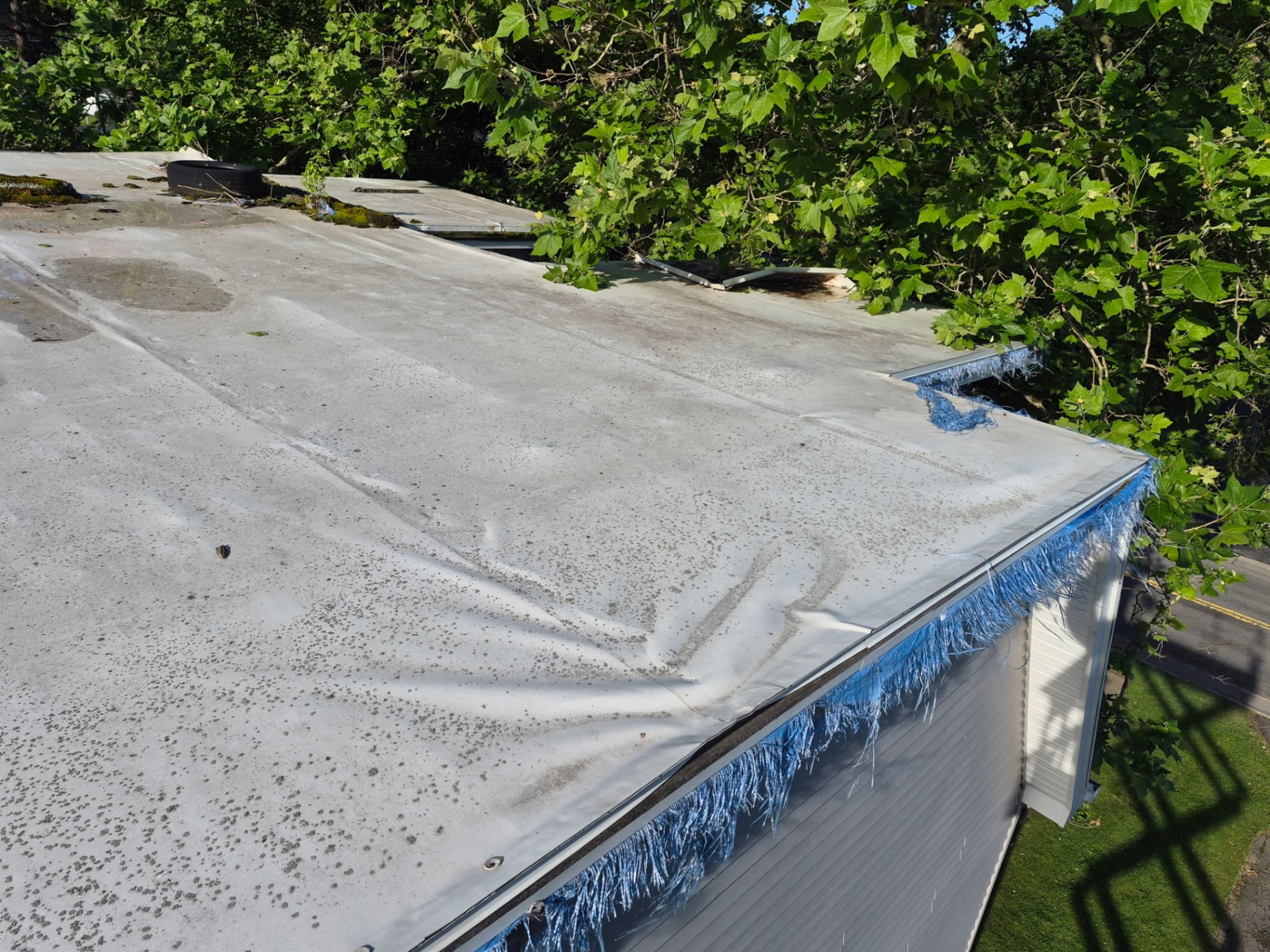 Before — EPDM rubber roof replacement — worn, weathered membrane swapped for fresh seamless EPDM